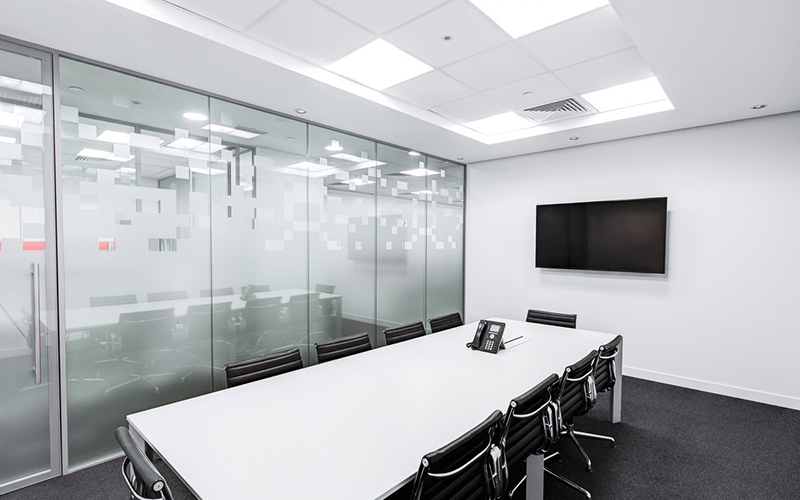 Empty meeting room with a big screen on the wall