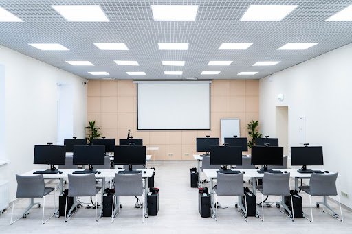 Modern classroom with desktop computers and whiteboard