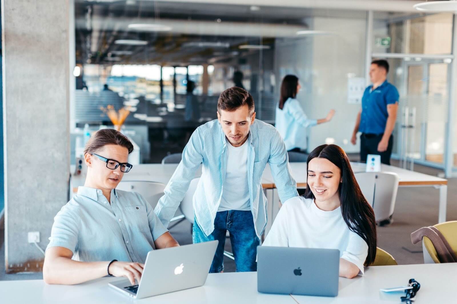 Young group of colleagues working in an open plan office space 